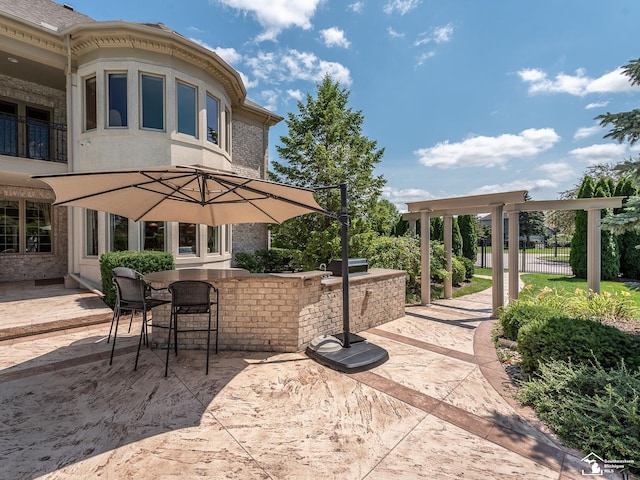 view of patio featuring an outdoor bar