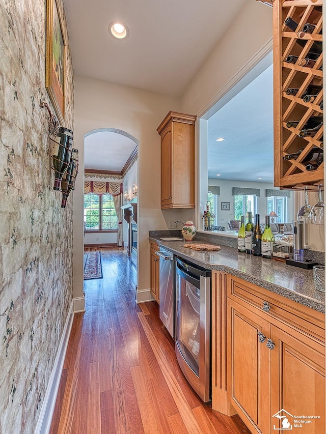 kitchen featuring plenty of natural light, dark hardwood / wood-style flooring, and wine cooler