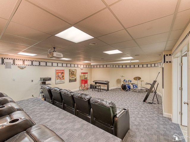 cinema with a paneled ceiling and carpet floors