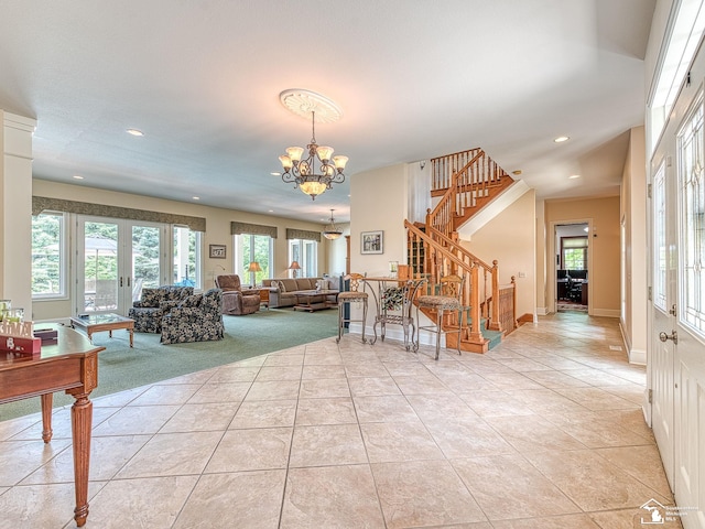 tiled living room featuring french doors and a notable chandelier