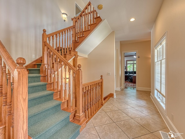 staircase featuring tile patterned flooring