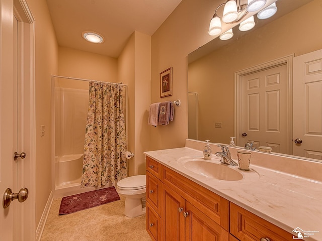 bathroom featuring toilet, vanity, and a shower with shower curtain