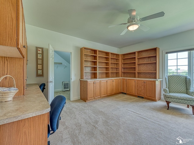 carpeted office space featuring heating unit and ceiling fan