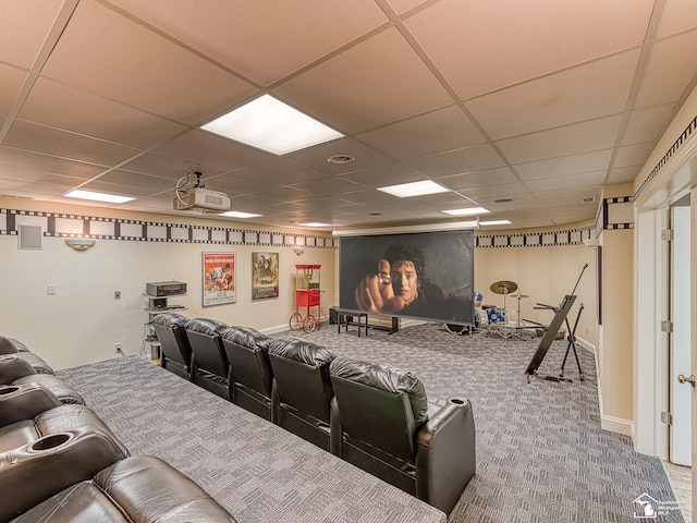 carpeted cinema room featuring a paneled ceiling