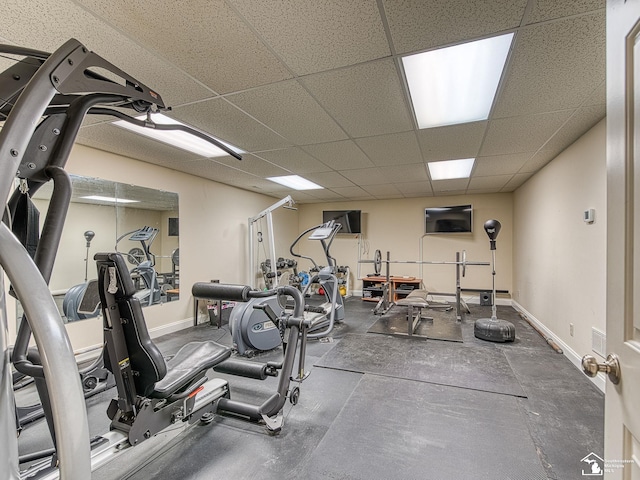 exercise room with a paneled ceiling