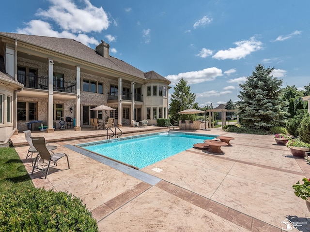 view of swimming pool with a patio