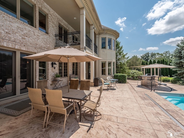 view of patio featuring a balcony