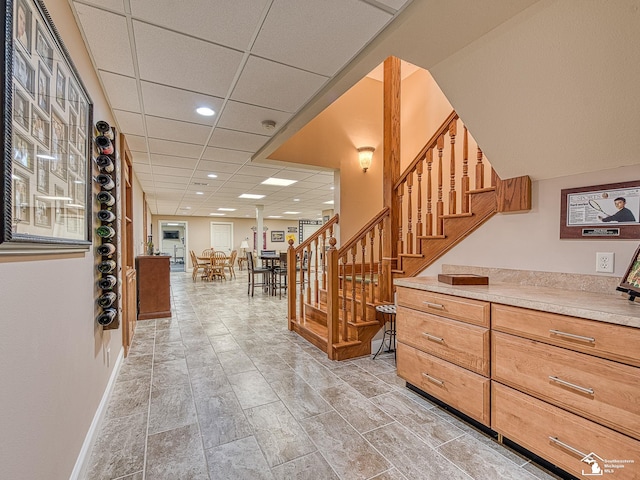 stairs featuring a drop ceiling