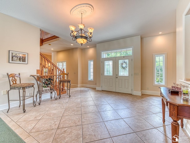 foyer featuring light tile patterned floors and a notable chandelier