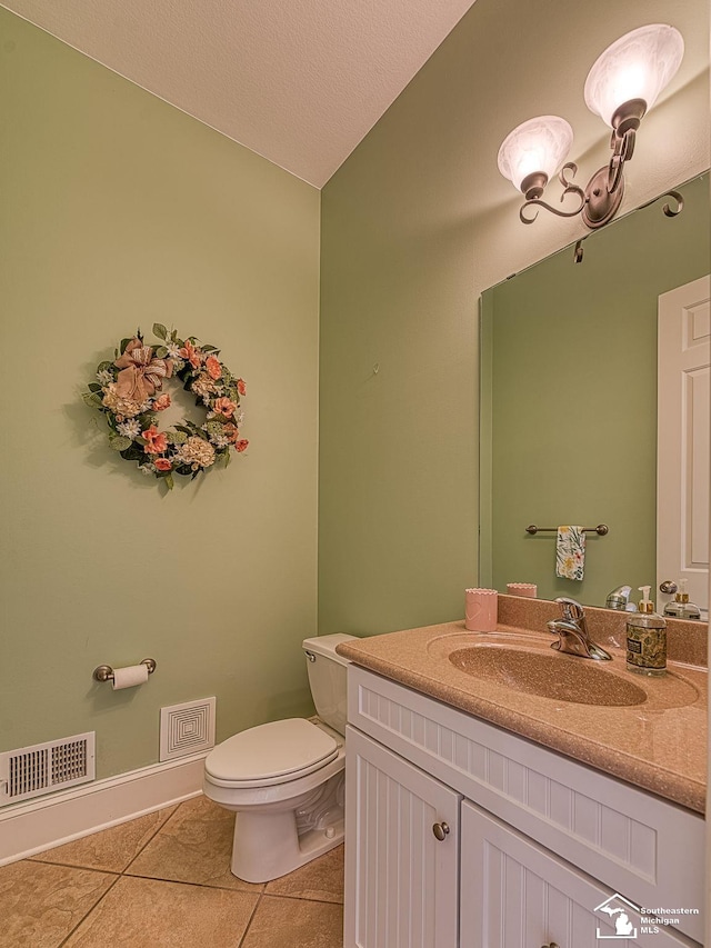 bathroom with a textured ceiling, vanity, tile patterned flooring, toilet, and lofted ceiling