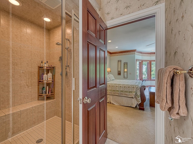 bathroom with a shower with door and ornamental molding