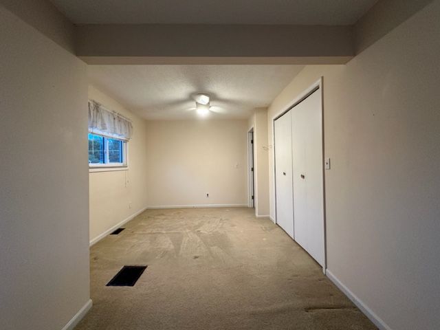 interior space featuring light carpet