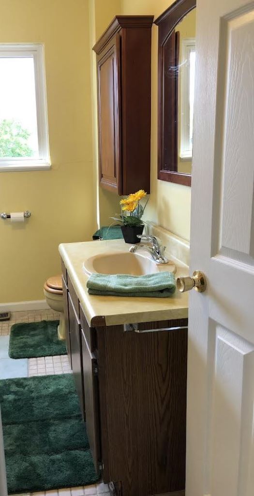 bathroom with tile patterned flooring, vanity, and toilet