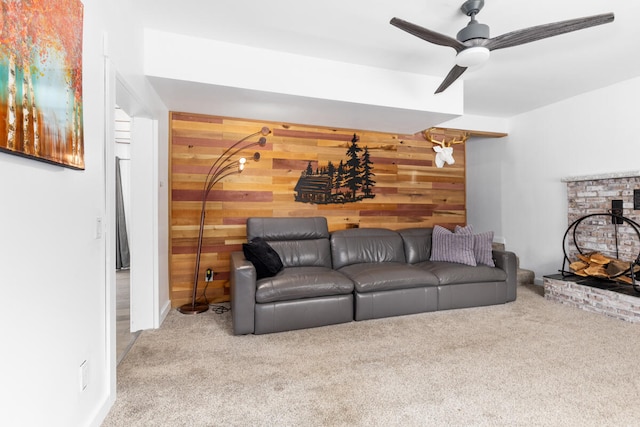 living room with ceiling fan, light carpet, and wooden walls