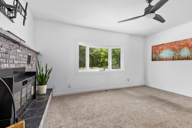 unfurnished living room with dark carpet and ceiling fan