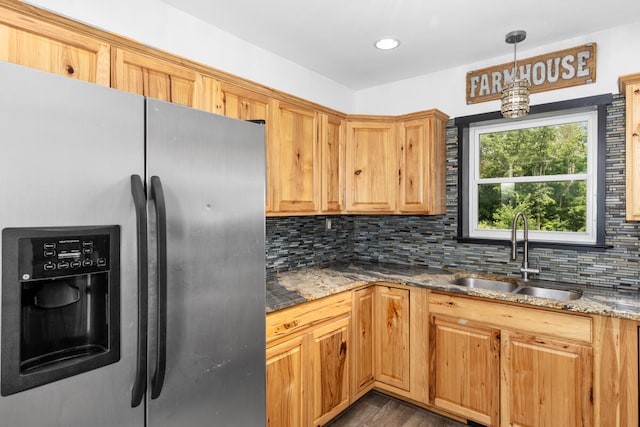 kitchen with stainless steel fridge, decorative light fixtures, tasteful backsplash, and sink