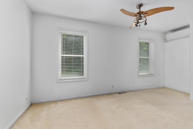 carpeted spare room with ceiling fan and an AC wall unit