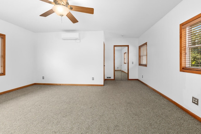 carpeted spare room with a wall mounted AC and ceiling fan