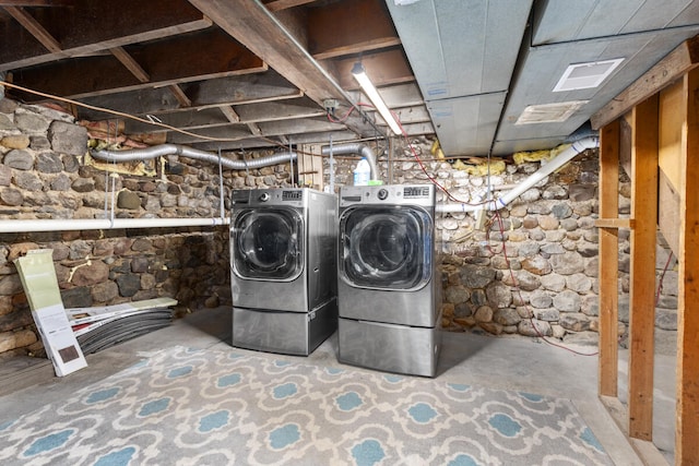 clothes washing area featuring washer and dryer