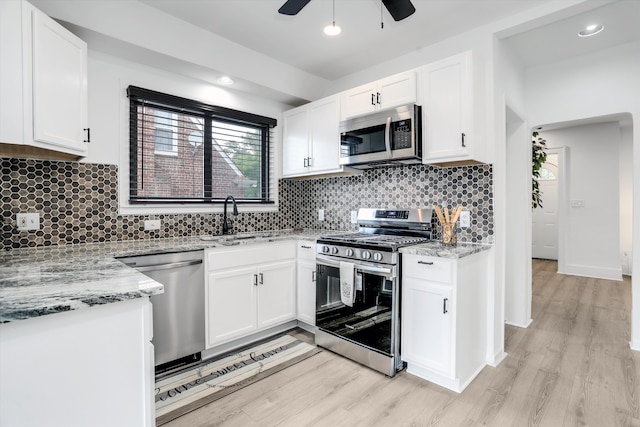 kitchen featuring white cabinets, light hardwood / wood-style floors, sink, and stainless steel appliances