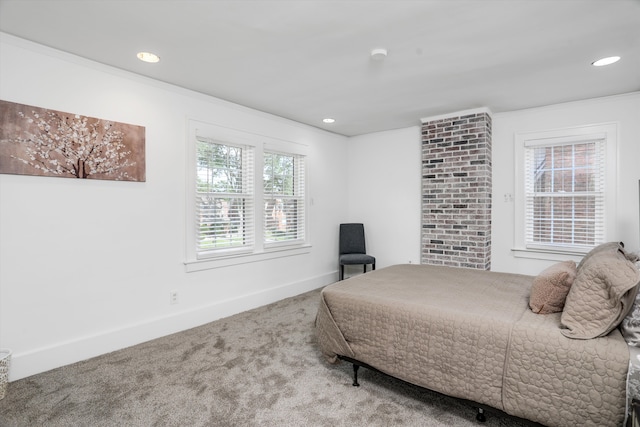 carpeted bedroom with crown molding and multiple windows