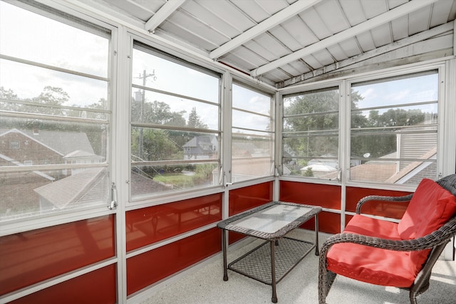 sunroom / solarium featuring wood ceiling, vaulted ceiling with beams, and a healthy amount of sunlight