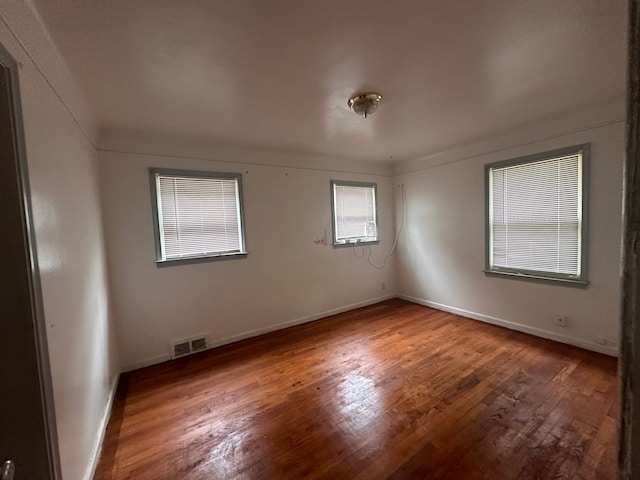 spare room with hardwood / wood-style flooring