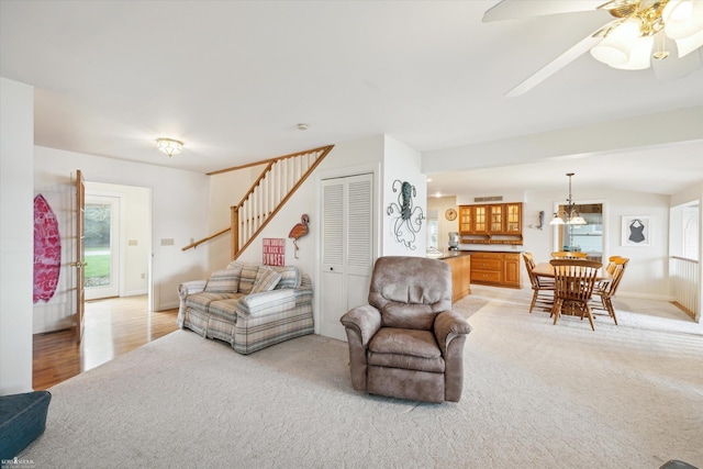 living room featuring light colored carpet and ceiling fan