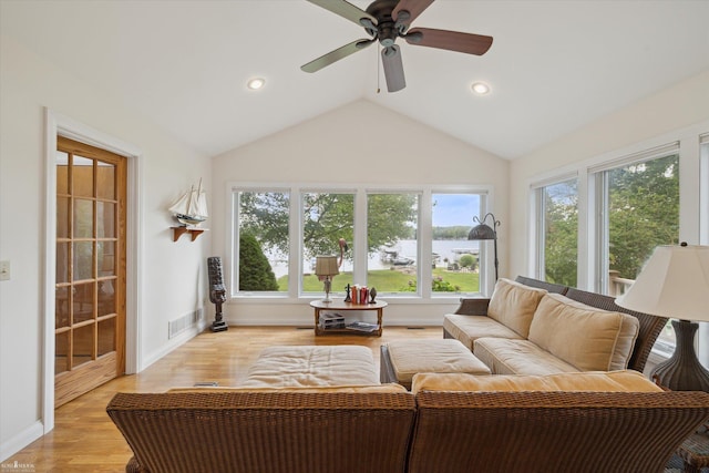 sunroom / solarium with ceiling fan and vaulted ceiling