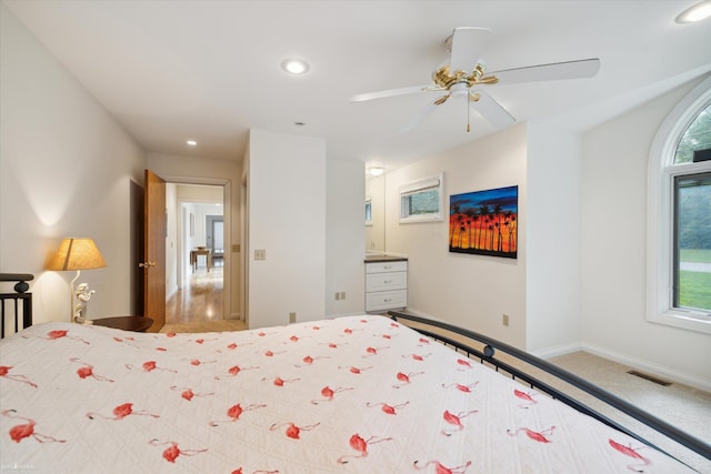 carpeted bedroom with ceiling fan