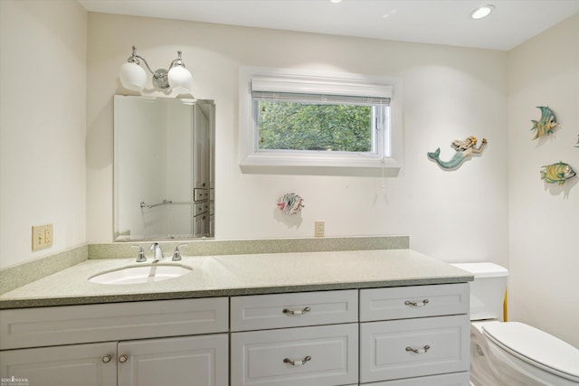 bathroom featuring vanity and toilet