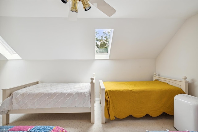 bedroom with ceiling fan and lofted ceiling with skylight