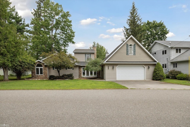 view of property with a garage and a front lawn