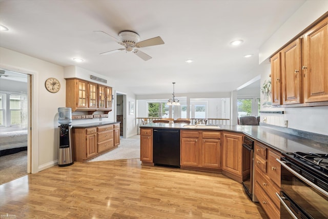 kitchen with pendant lighting, black dishwasher, sink, and a wealth of natural light