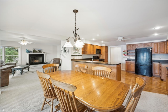 dining room featuring light hardwood / wood-style floors and ceiling fan