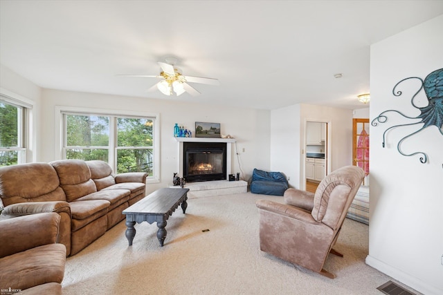 carpeted living room featuring ceiling fan