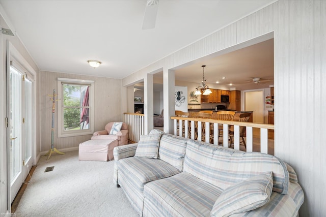 living room featuring carpet and ceiling fan