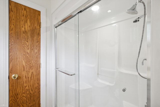 bathroom with a shower with shower door