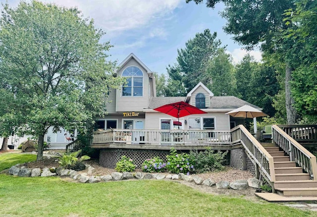 back of house featuring a yard and a deck