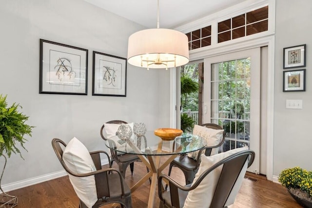 dining room featuring dark wood-type flooring and a chandelier