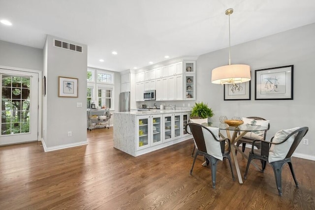 dining space with dark hardwood / wood-style flooring