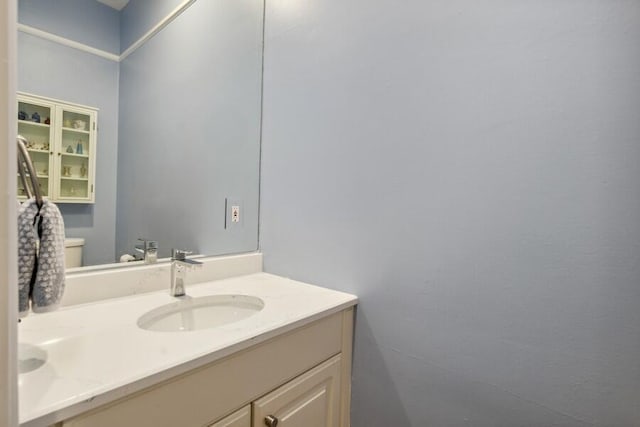 bathroom featuring vanity and toilet