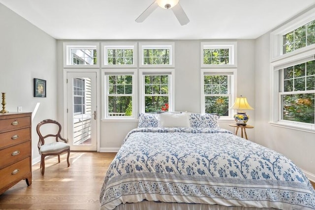 bedroom with ceiling fan and light hardwood / wood-style floors