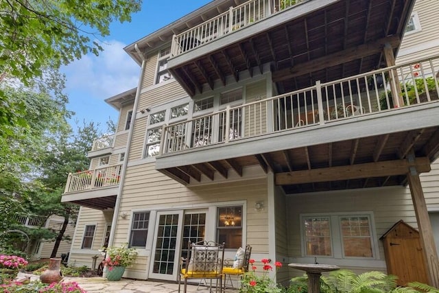 rear view of property featuring a balcony