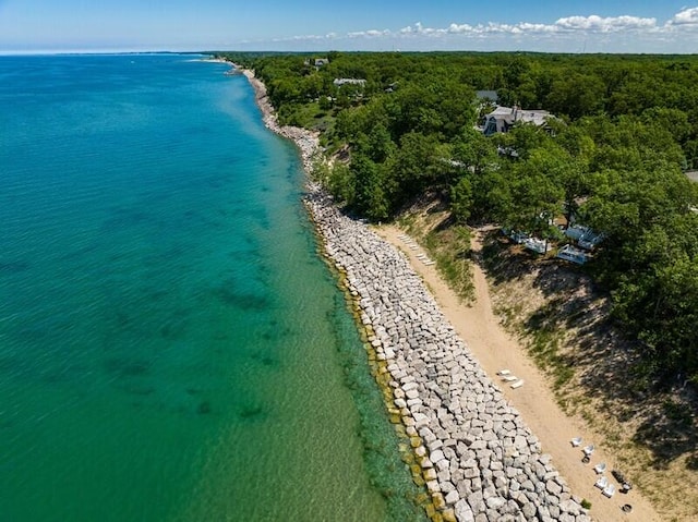 birds eye view of property with a water view and a view of the beach