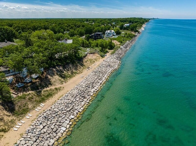 birds eye view of property with a water view and a beach view