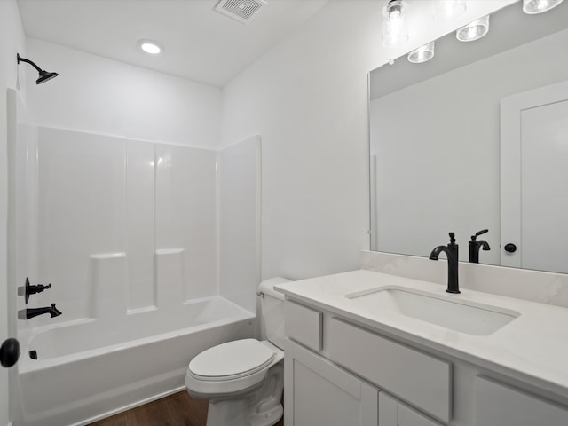 full bathroom with toilet, vanity, shower / washtub combination, and hardwood / wood-style flooring