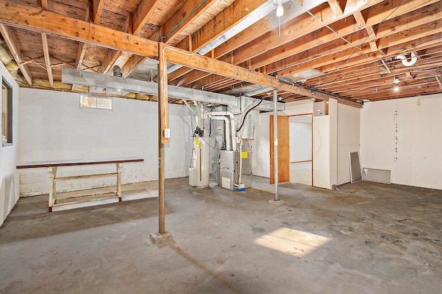 basement featuring heating unit and water heater