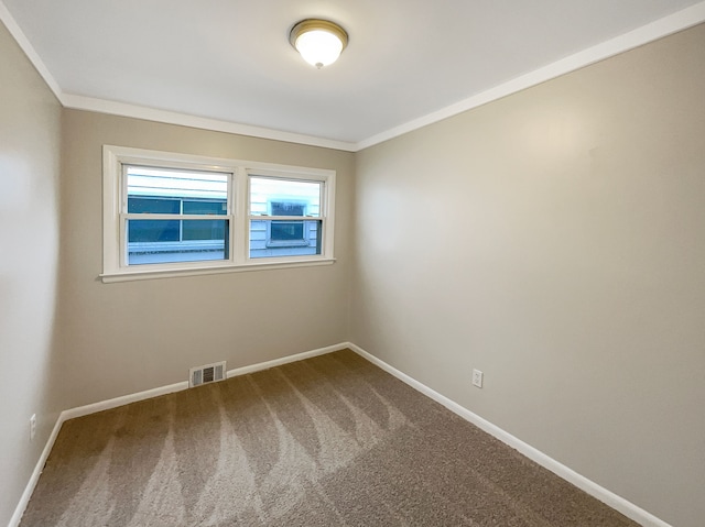 carpeted spare room featuring ornamental molding