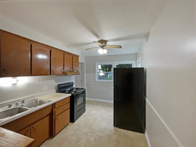 kitchen with black appliances, ceiling fan, sink, and tasteful backsplash